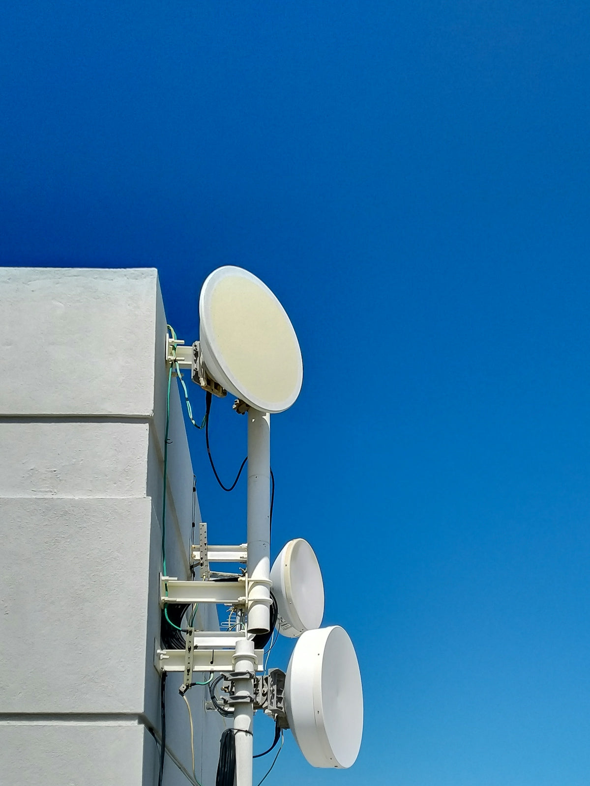 a satellite dish mounted to the side of a building