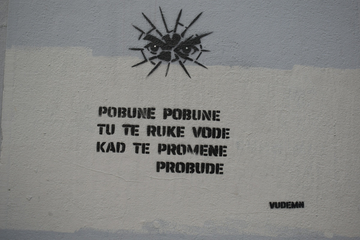 Graffiti with eyes and text on a wall