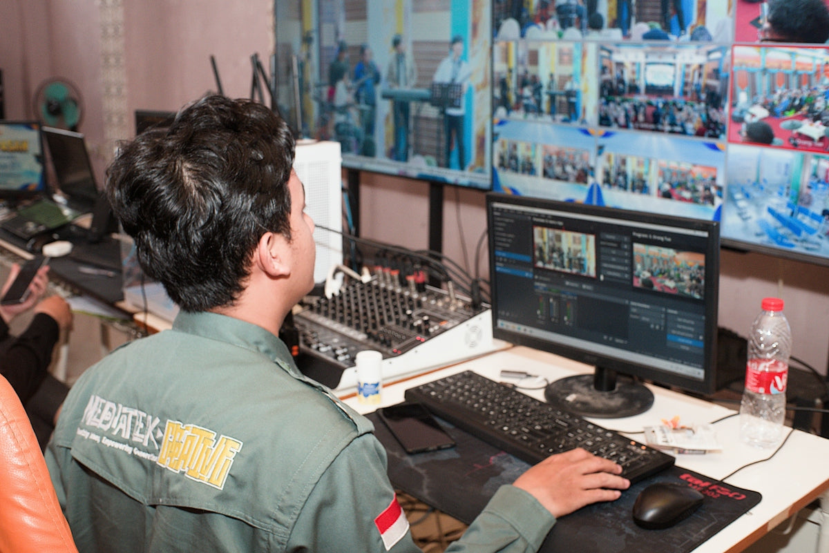 Man in uniform operating video and audio equipment