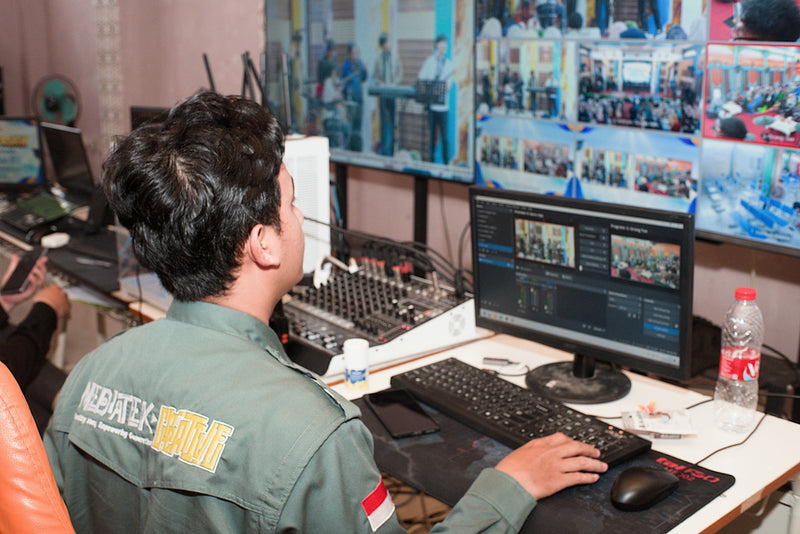 Man in uniform operating video and audio equipment
